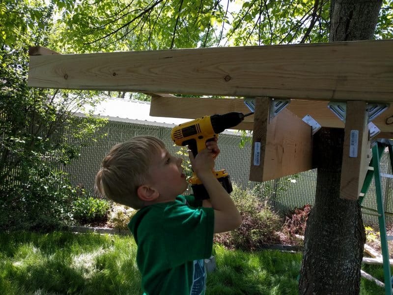 Eli trying to use a drill ...he can't quite hold it up and position it correctly