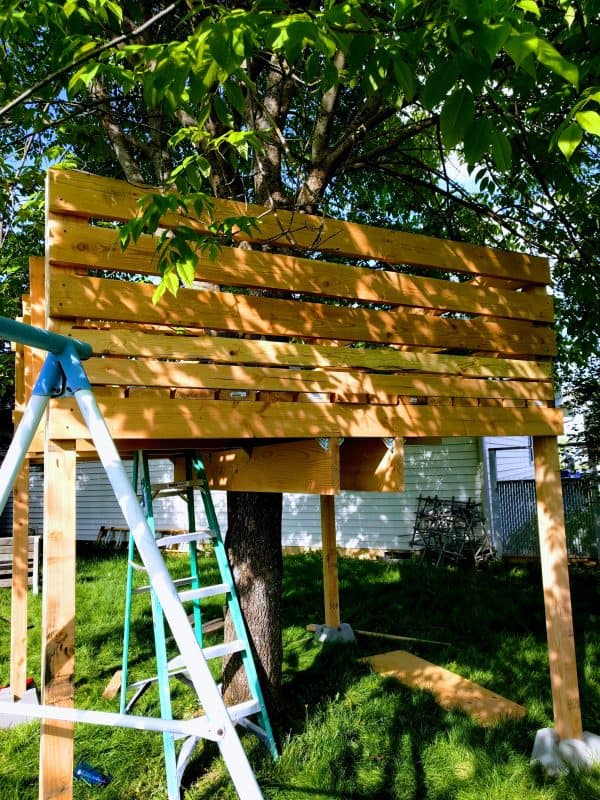 Another angle outside of tree-house showing wall.