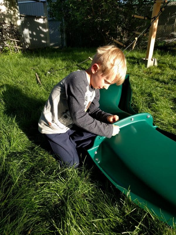 Eli attaching two parts of slide with bolts