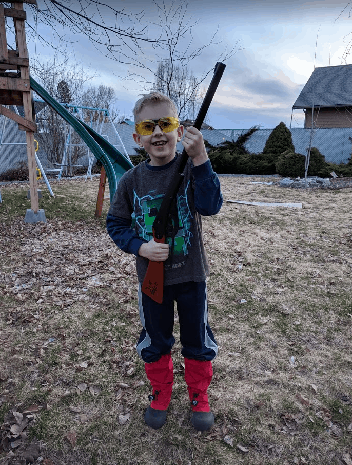 Eli holding Daisy Buck BB Gun