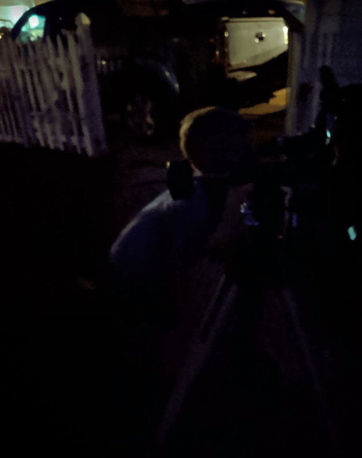 Eli looking through telescope