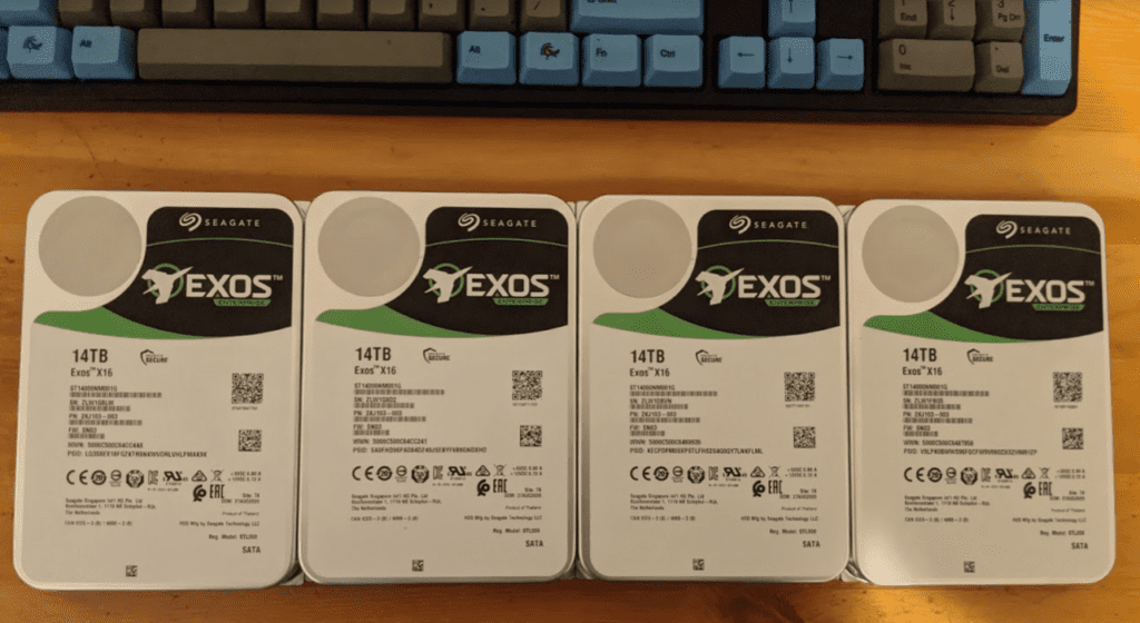 Four 14TB Seagate Exos drives ready to install.