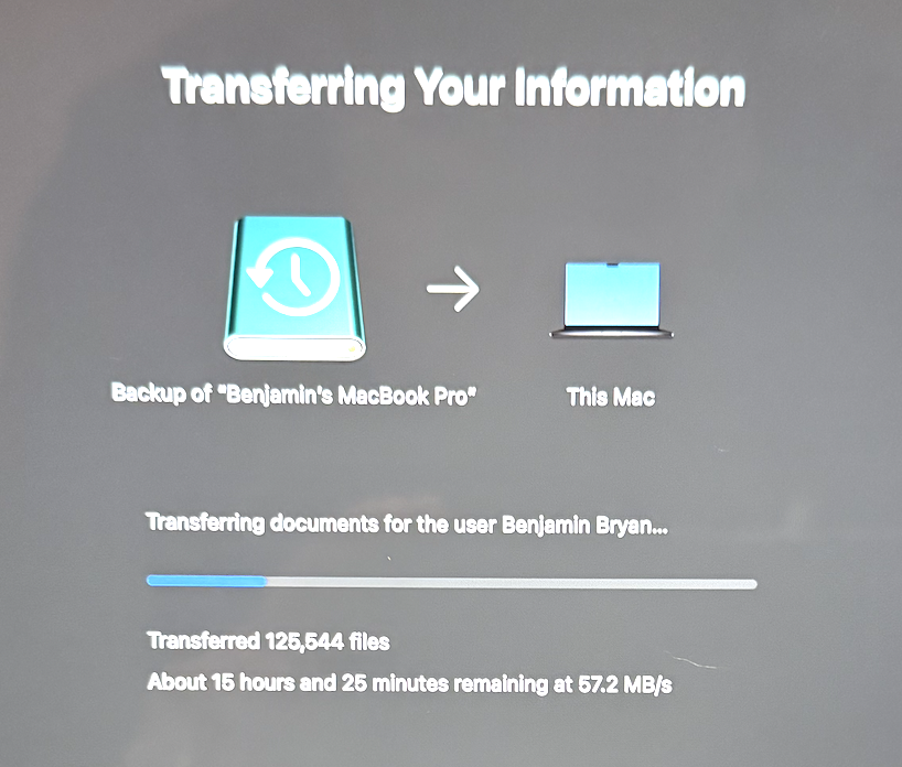 Photo of Mac screen transferring information.  Showing 15% progress.